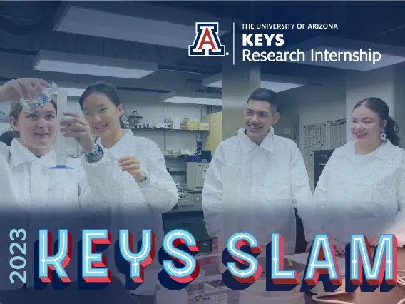 Four high school students wearing white lab coats and staring at a graduated cylinder one student is holding. They're smiling. The text at the bottom reads "2023 KEYS Slam."