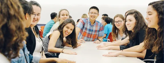 KEYS Students sitting around a table laughing