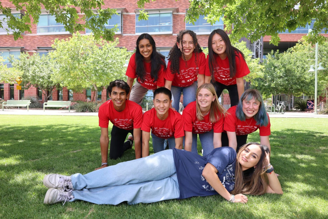 Young people smiling in a human pyramid