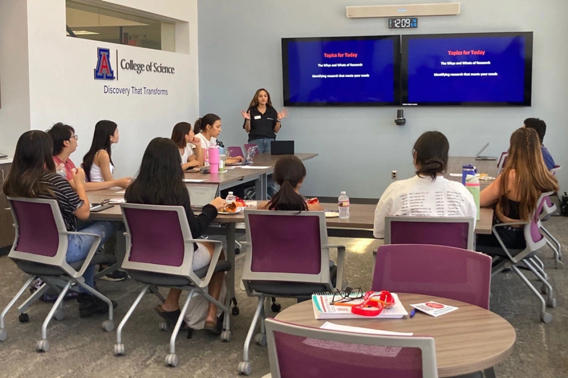 Person speaking a group of people in a modern classroom