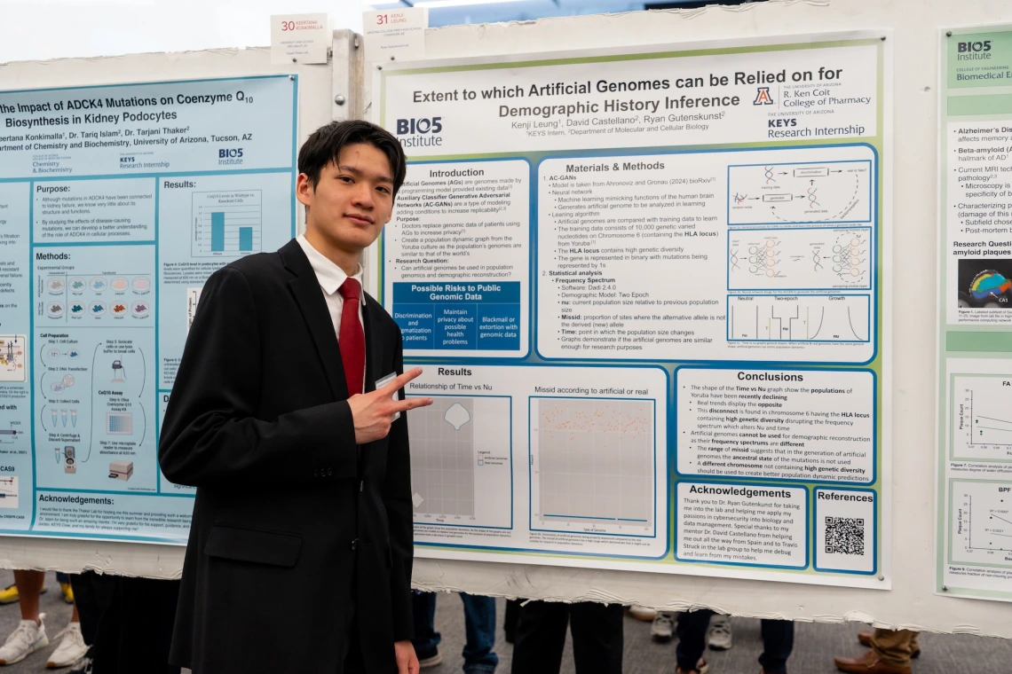 Individual presenting a scientific poster on the reliability of artificial genomes for demographic history inference at a showcase.