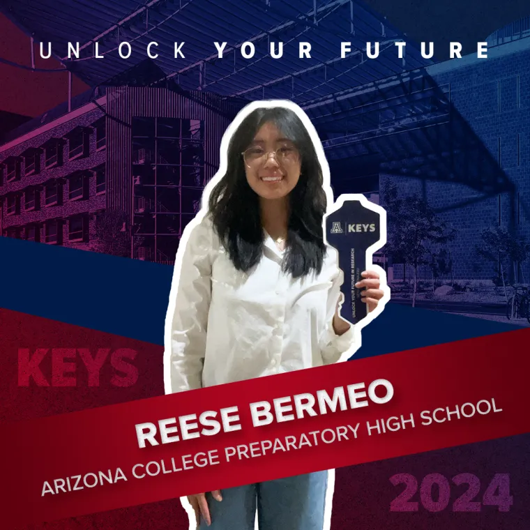 A high school student holding a paper key