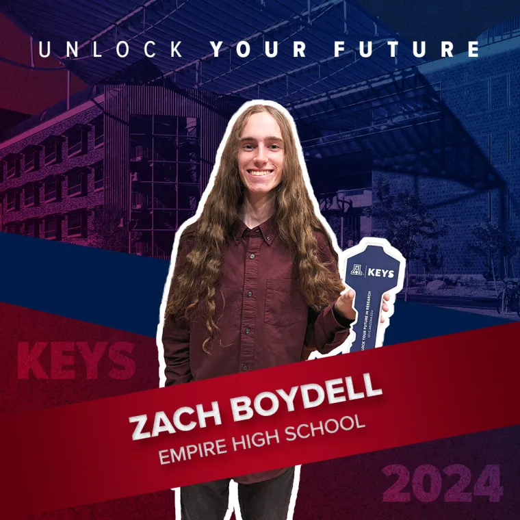 A high school student holding a paper key