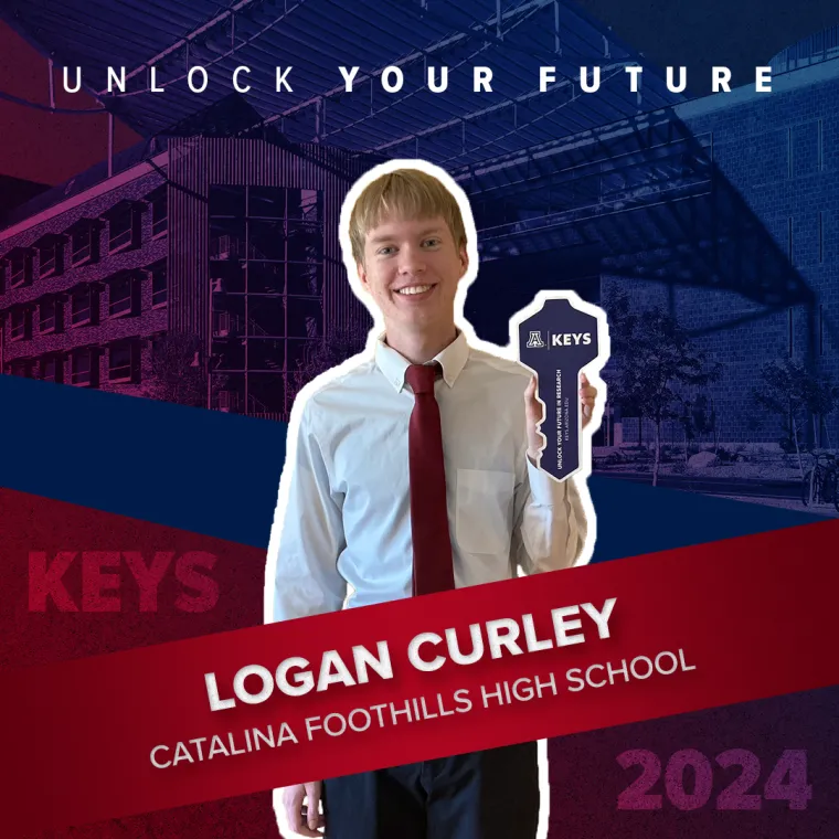 A high school student holding a paper key