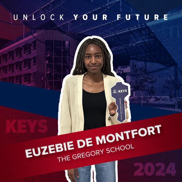 A high school student holding a paper key