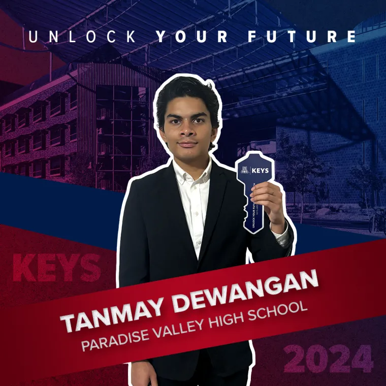 A high school student holding a paper key