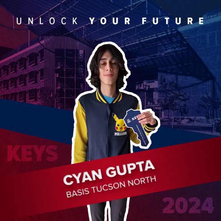 A high school student holding a paper key