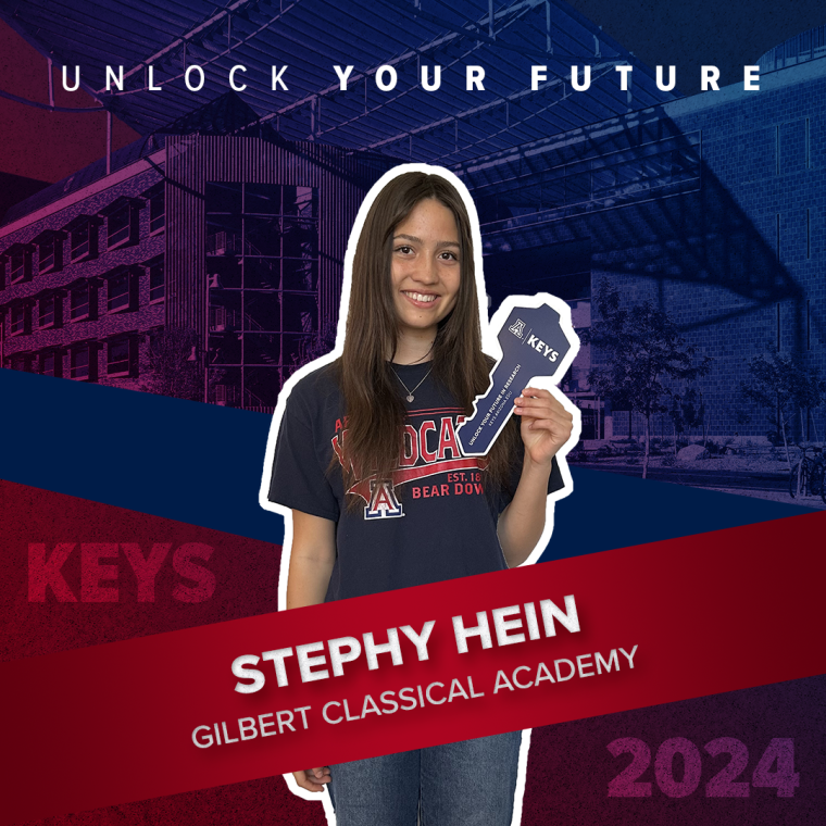 A high school student holding a paper key