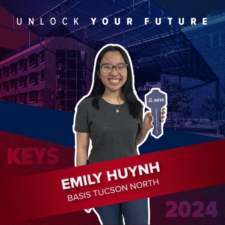 A high school student holding a paper key