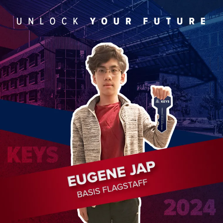 A high school student holding a paper key