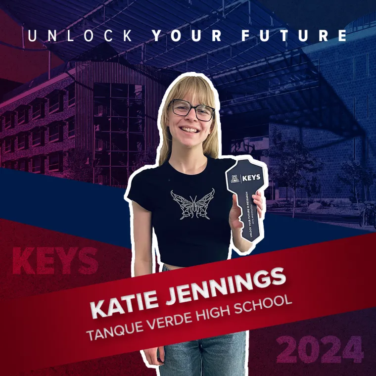 A high school student holding a paper key