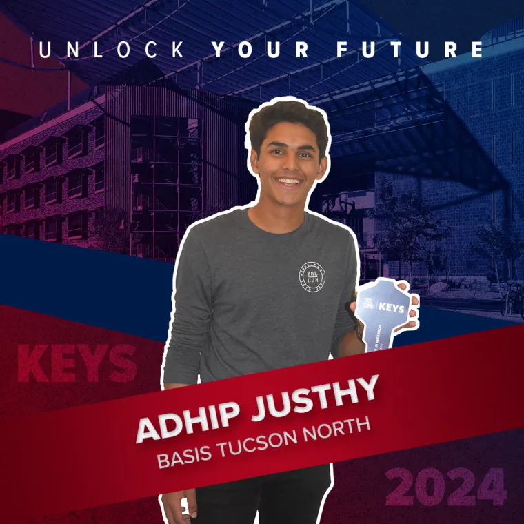 A high school student holding a paper key