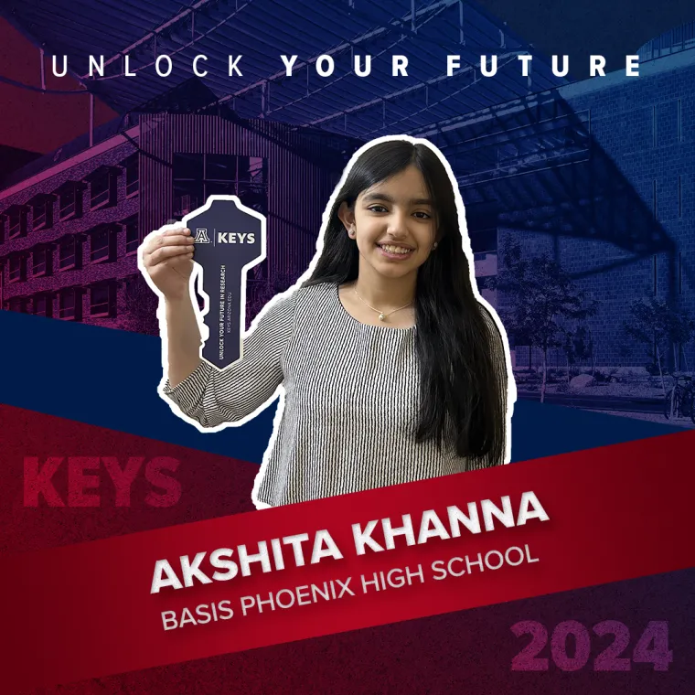A high school student holding a paper key