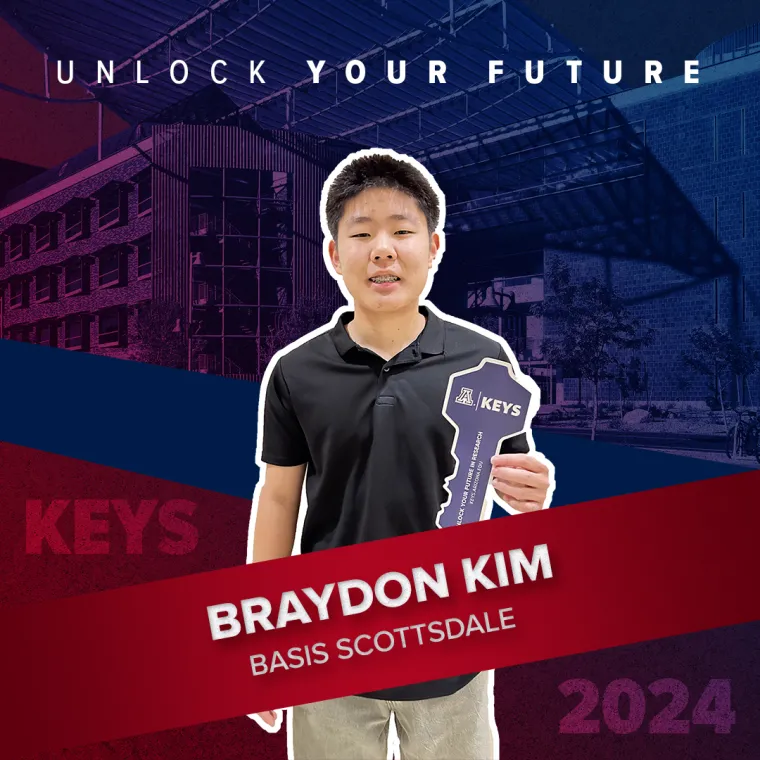 A high school student holding a paper key