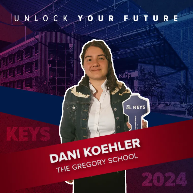 A high school student holding a paper key