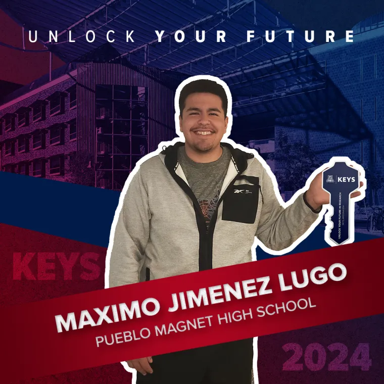 A high school student holding a paper key