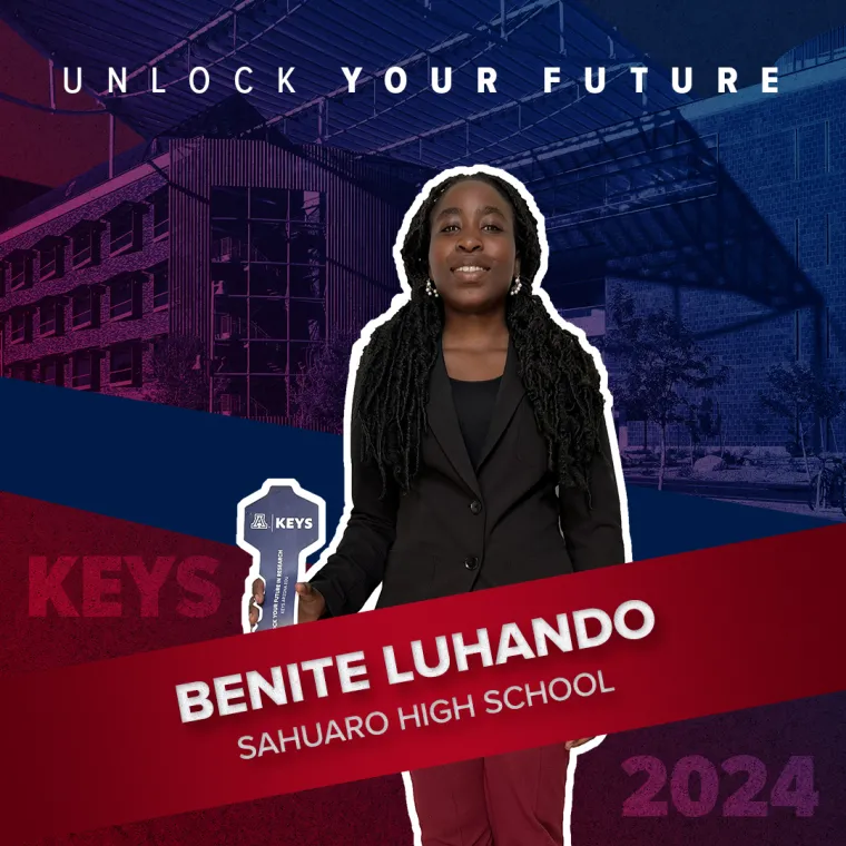 A high school student holding a paper key