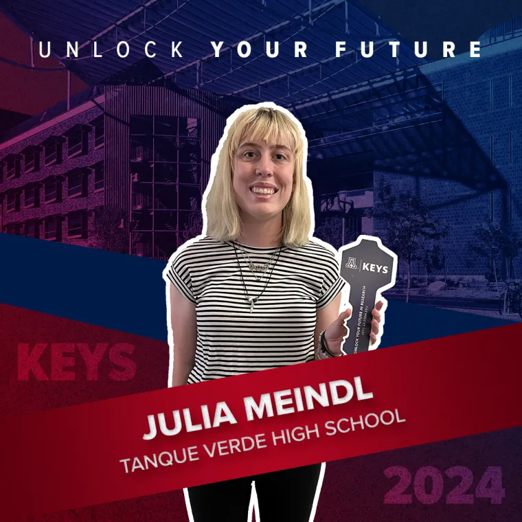 A high school student holding a paper key