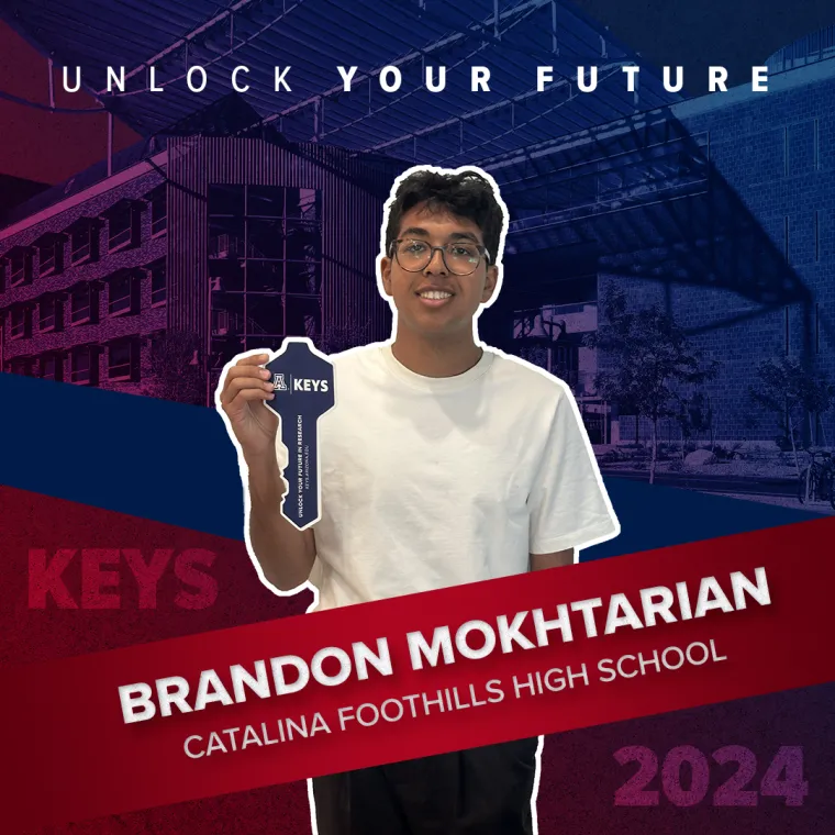A high school student holding a paper key