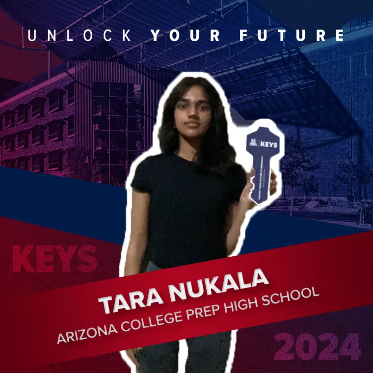A high school student holding a paper key