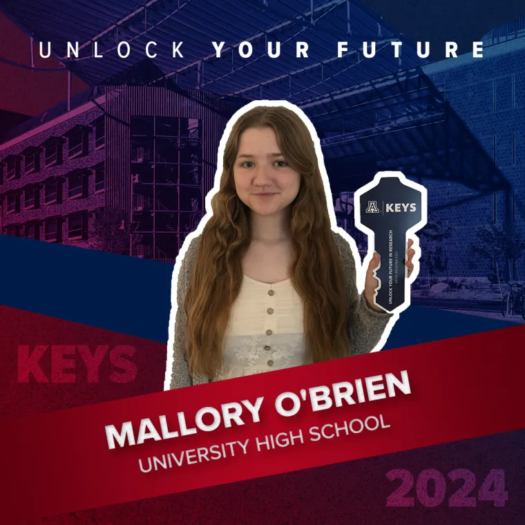 A high school student holding a paper key