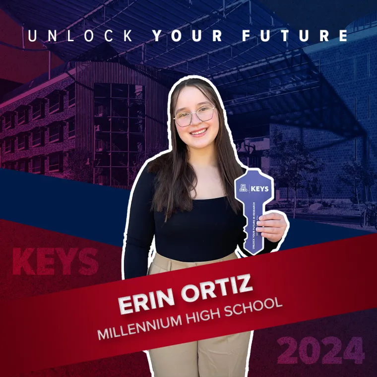 A high school student holding a paper key
