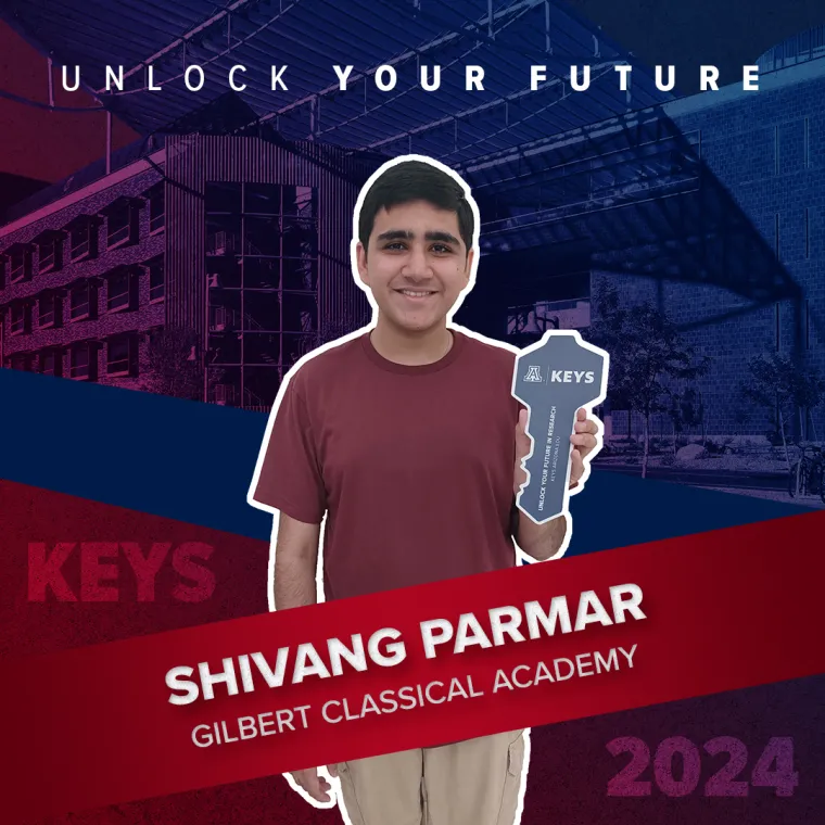 A high school student holding a paper key