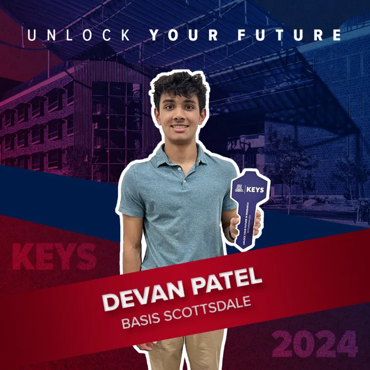 A high school student holding a paper key