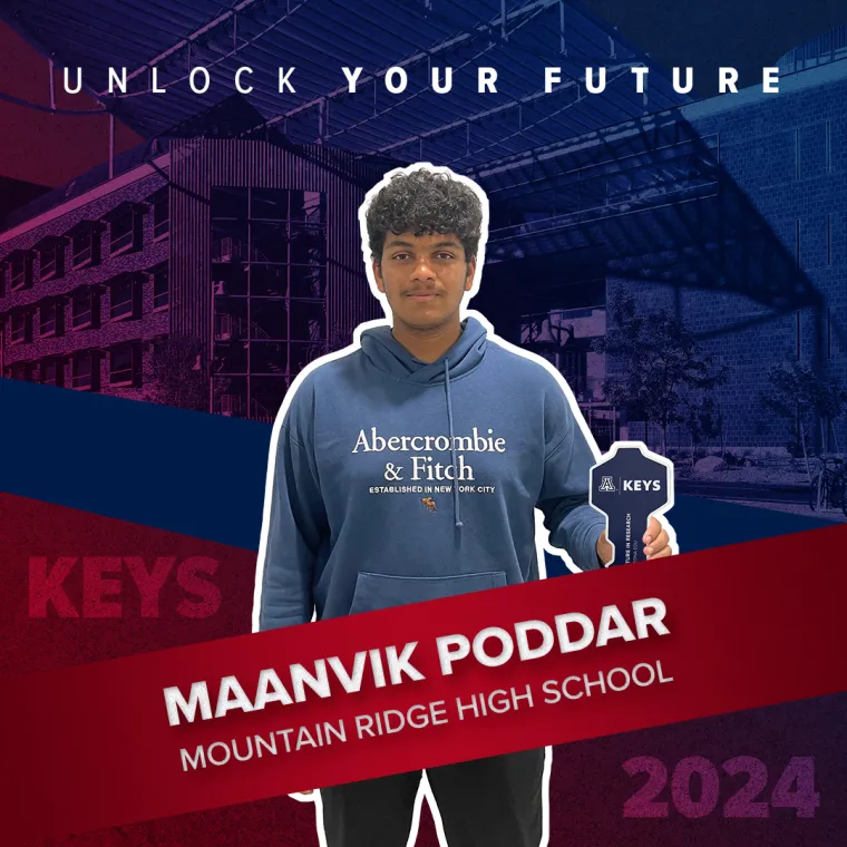 A high school student holding a paper key