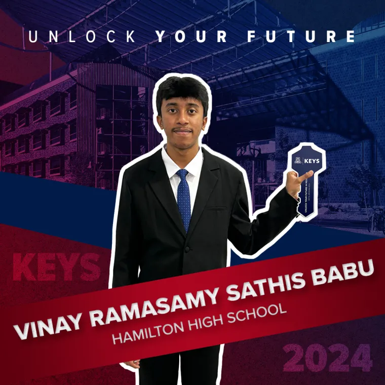 A high school student holding a paper key