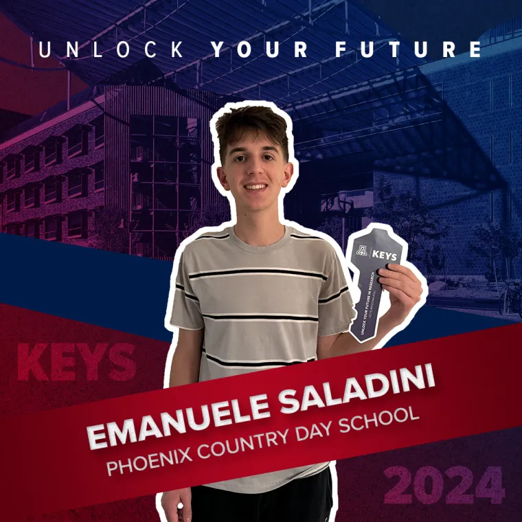 A high school student holding a paper key