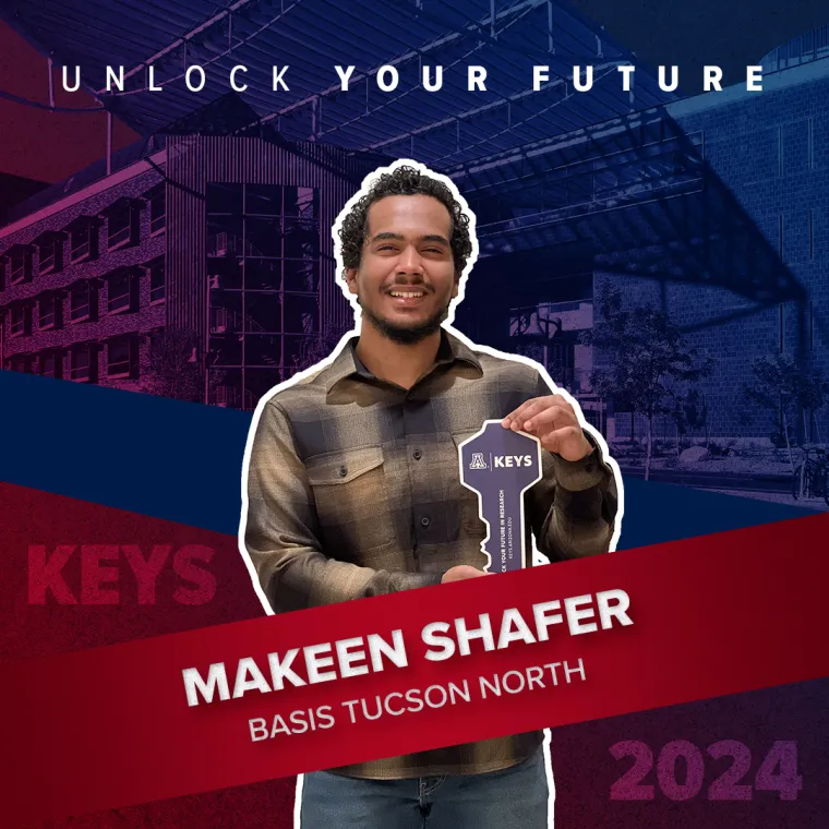 A high school student holding a paper key