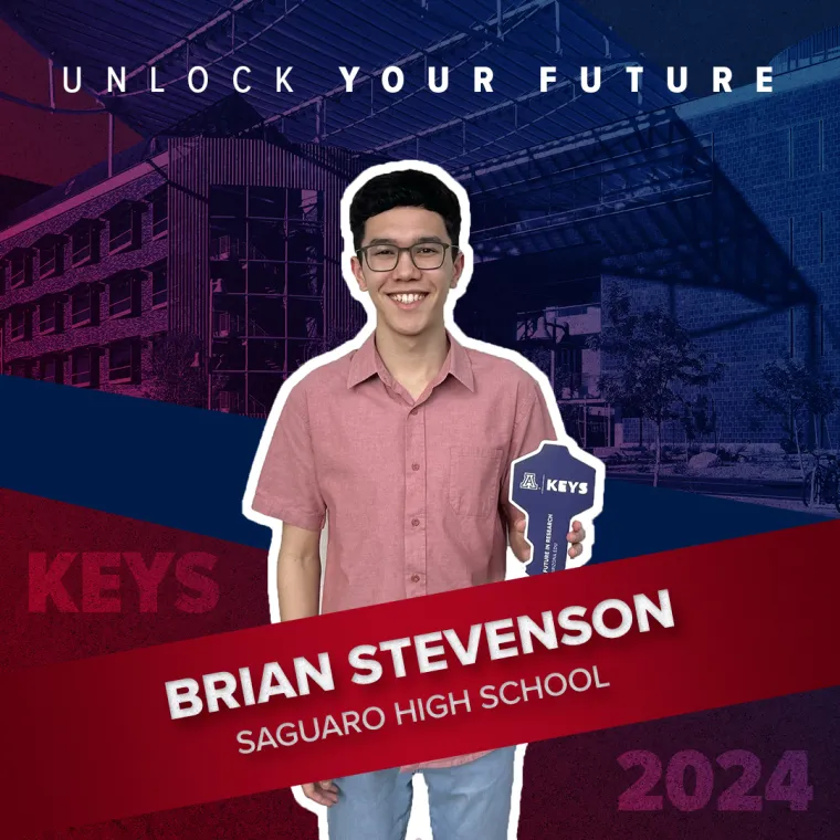 A high school student holding a paper key