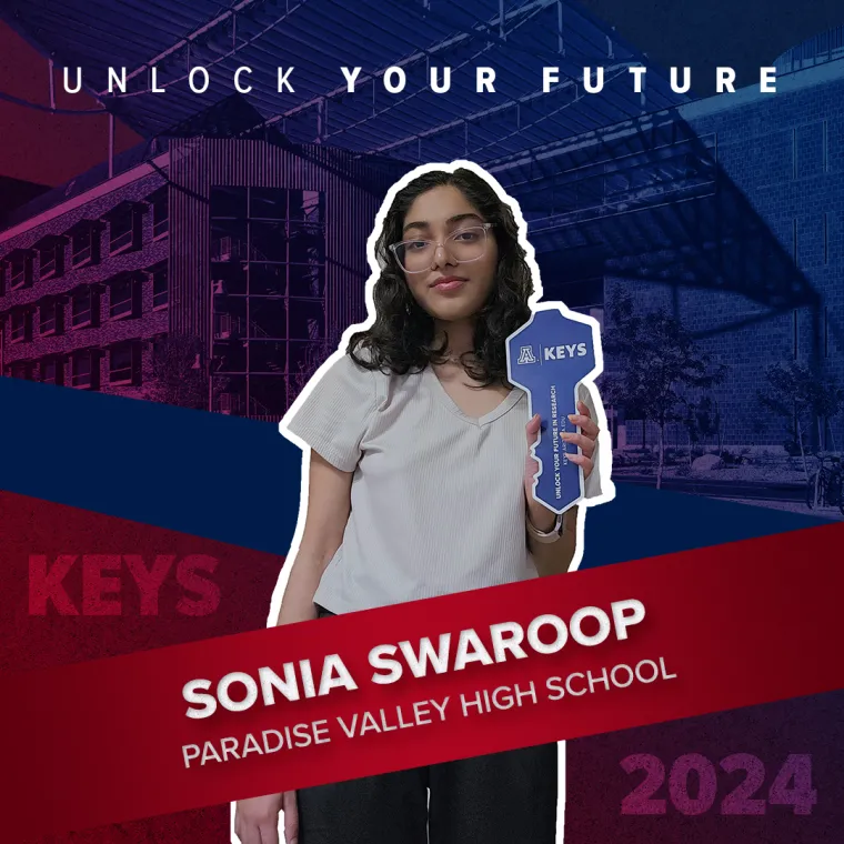 A high school student holding a paper key