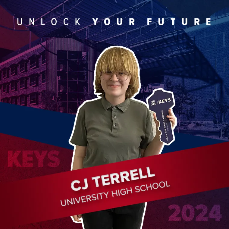 A high school student holding a paper key