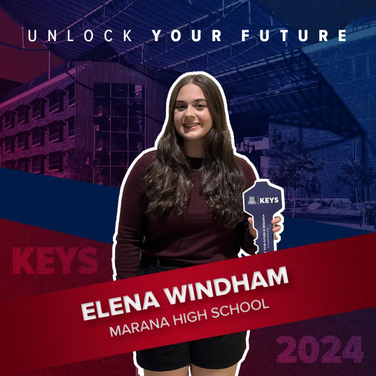 A high school student holding a paper key
