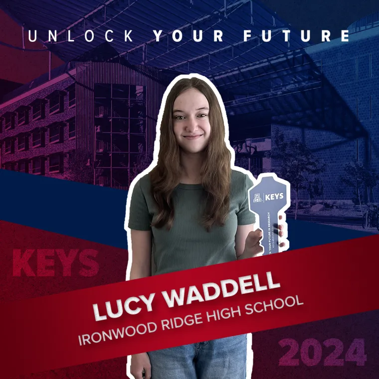 A high school student holding a paper key