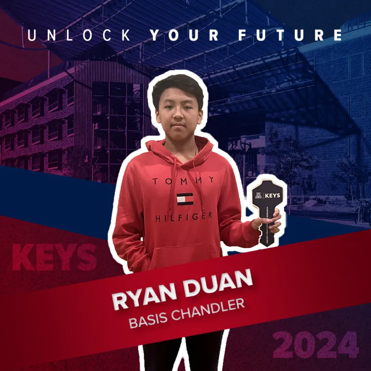 A high school student holding a paper key