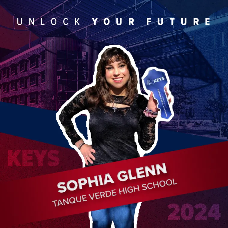 A high school student holding a paper key