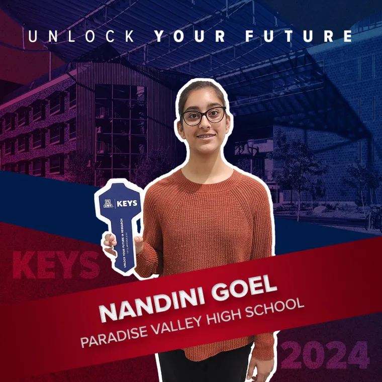 A high school student holding a paper key