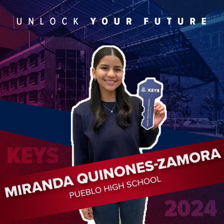 A high school student holding a paper key