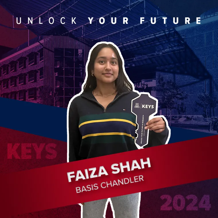 A high school student holding a paper key