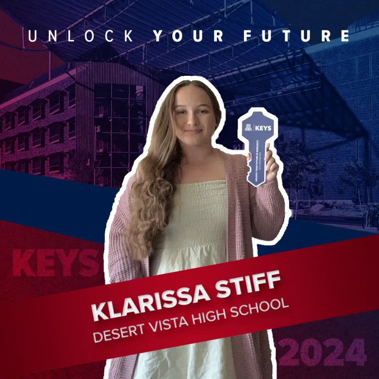 A high school student holding a paper key
