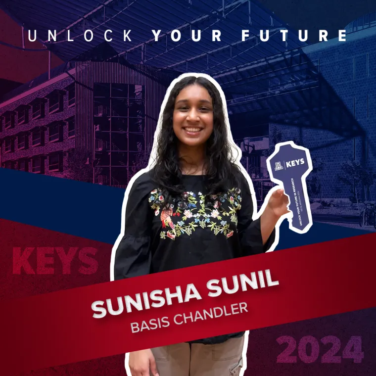 A high school student holding a paper key