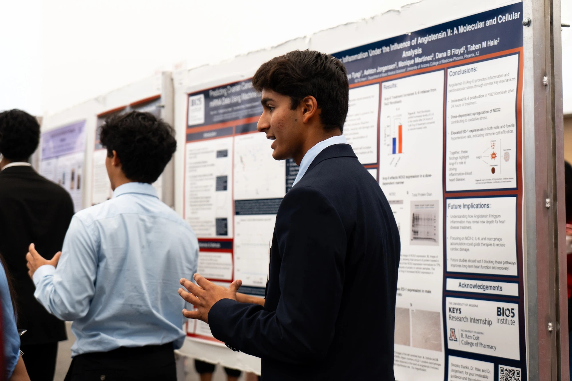 Attendees at a scientific conference discussing and reviewing poster presentations.