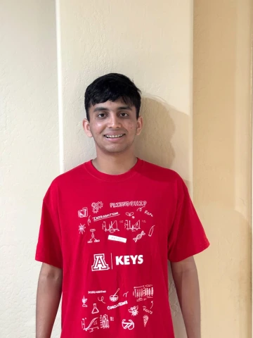 KEYS Intern wearing red shirt, with lighter background.