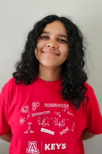 KEYS Intern wearing red shirt, with lighter background.