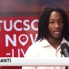 Mozani Zianti, a University of Arizona graduate, giving an interview on Tucson News Now, with the channel's logo visible in the background.